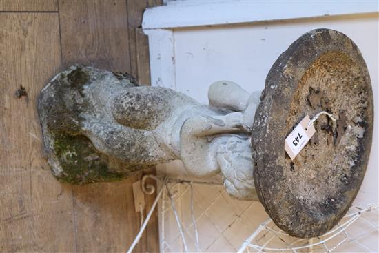 A reconstituted stone birdbath and pedestal